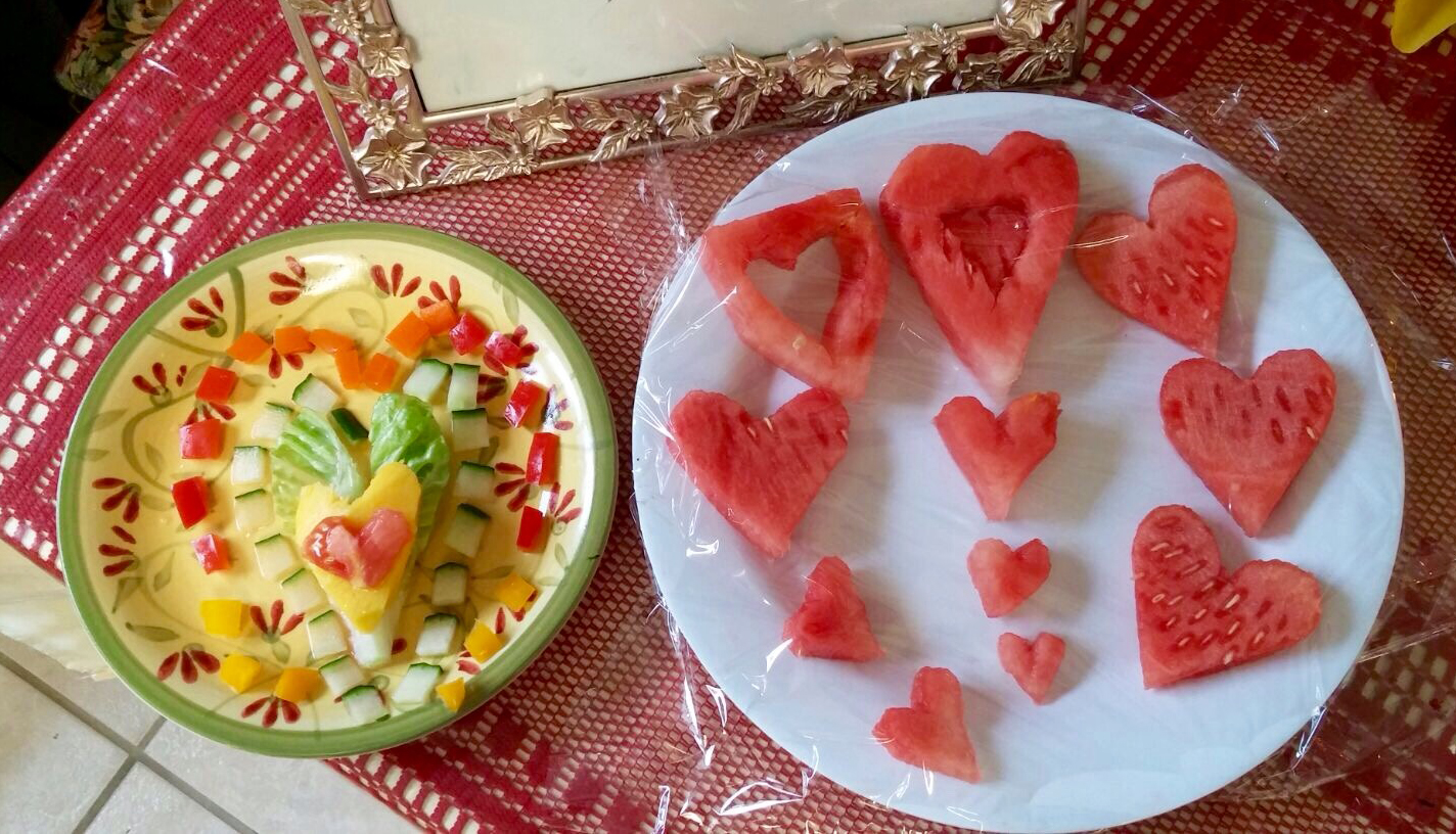 Fruits and vegetables cut and arranged in heart designs