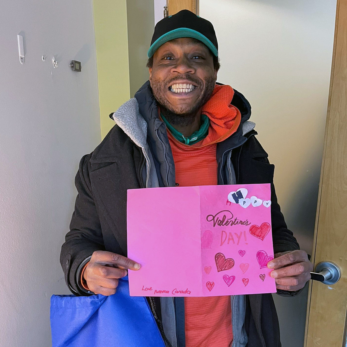 Smiling man holding handmade valentine card