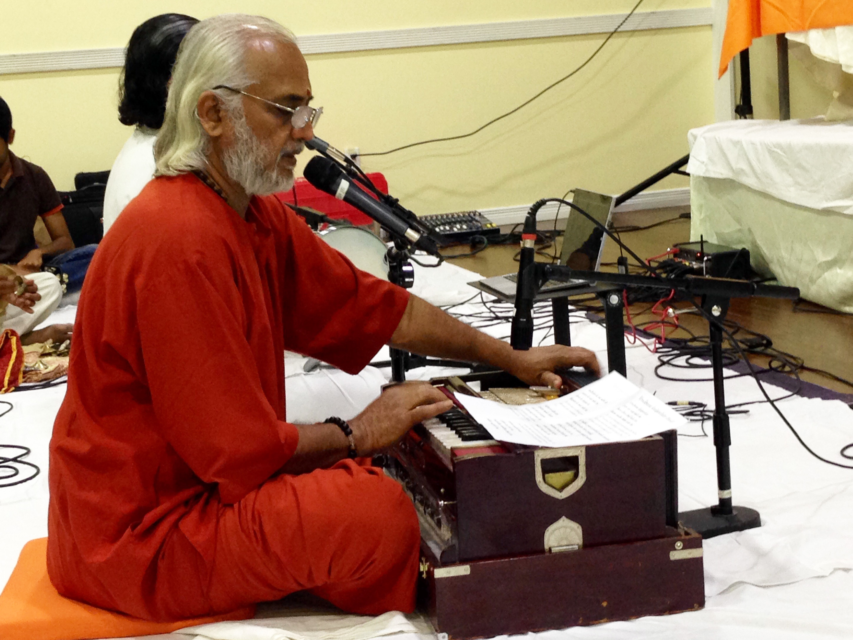 Swami Ramakrishnananda singing and playing harmonium