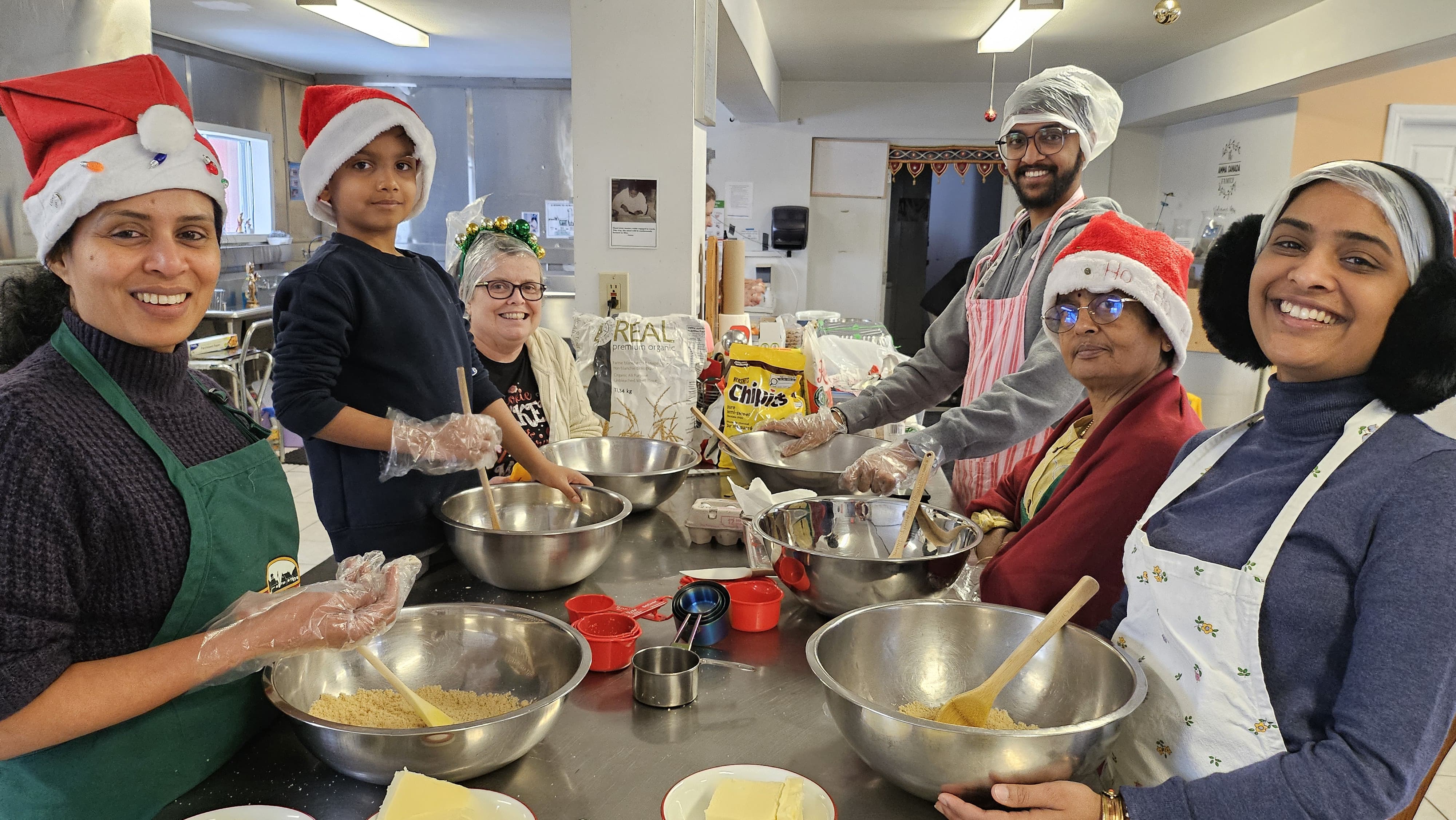 Volunteers baking Christmas cookies in Amma Canada kitchen